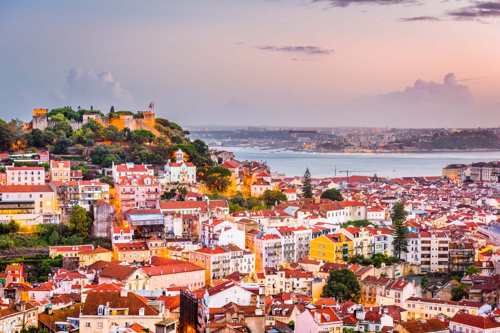 Lisbon, Portugal City Skyline with Sao Jorge Castle and Tagus River.